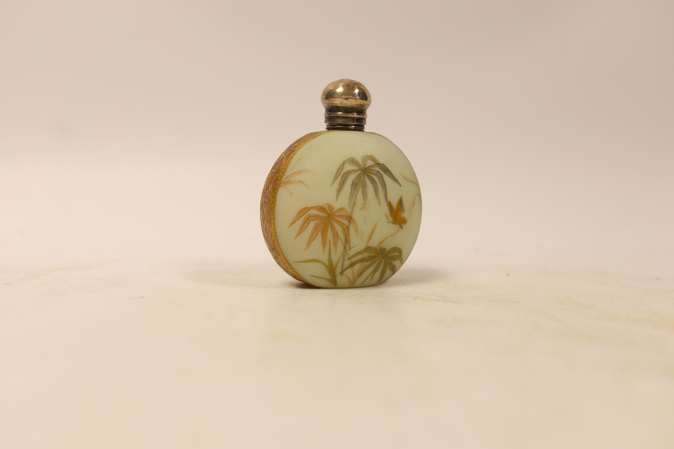 A late Victorian silver topped moon shaped opaline glass scent bottle, decorated with a bird and butterfly amongst flowers, William Oliver, Birmingham, 1894, 82mm.